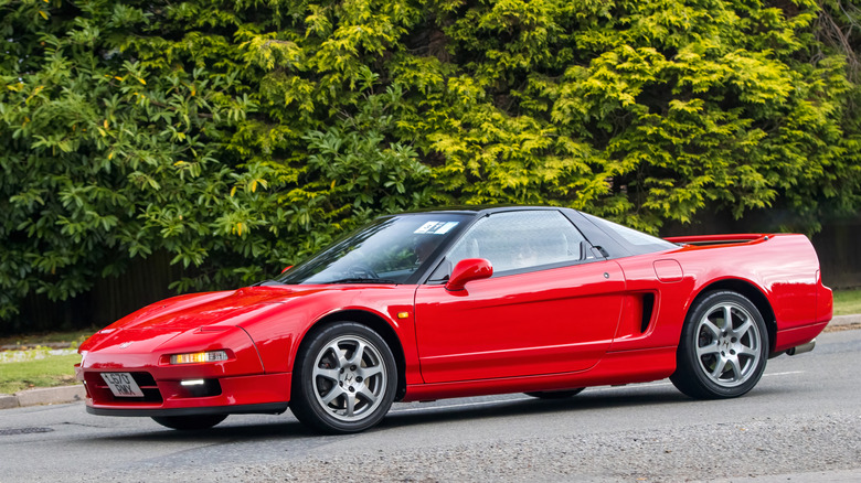 A red Honda NSX near a curb