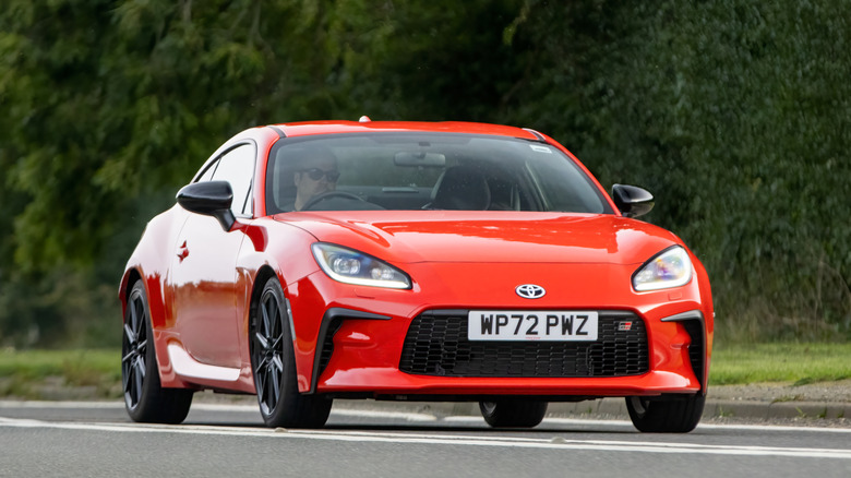 A red Toyota GR86 on a road