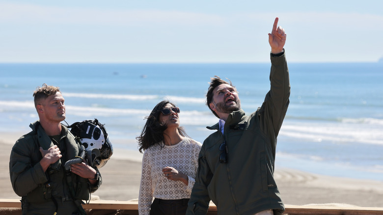 U.S. Vice President JD Vance (R) points at the aircraft flying overhead as he watches the America's Marines 250 event with his wife second lady Usha Vance at Camp Pendleton's Red Beach on October 18, 2025 in Oceanside, California.