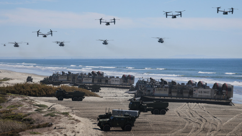 U.S. Navy Landing Craft Air Cushion's (LCAC) unload equipment onto the beach as U.S. Marine Corps V-22 Ospreys and CH-53 Super Stallions fly overhead during the America's Marines 250 event at Camp Pendleton's Red Beach on October 18, 2025 in Oceanside, California.