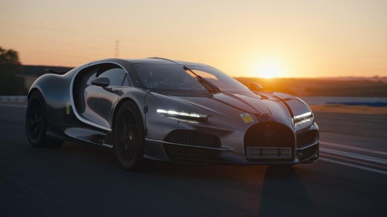 Front 3/4 view of a Bugatti Tourbillon undergoing testing on a racetrack in Spain.
