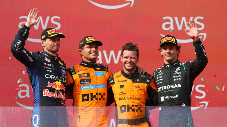 Race winner Lando Norris of Great Britain and McLaren Second placed Max Verstappen of the Netherlands and Oracle Red Bull Racing Third placed Andrea Kimi Antonelli of Italy and Mercedes AMG Petronas F1 Team and the McLaren trophy delegate on the podium during the F1 Grand Prix of Hungary at Hungaroring on July 26, 2026 in Budapest, Hungary.