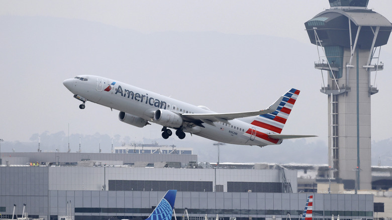 An American Airlines plane takes off from LAX