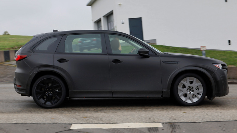 Side view of a Mazda electric SUV test mule