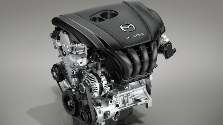 A SkyActiv-G engine against a grey background