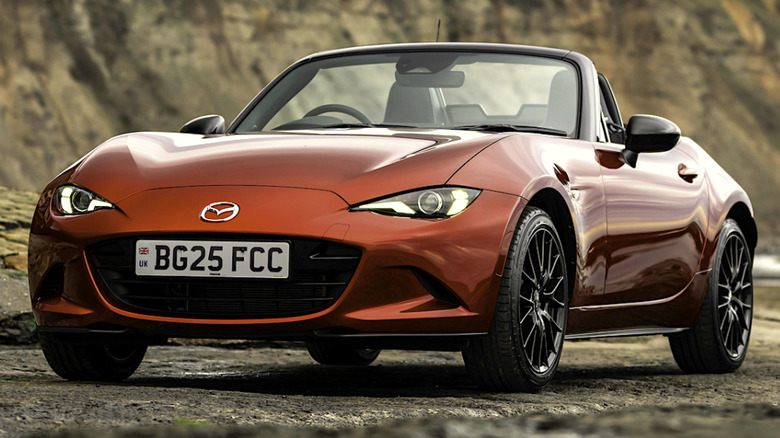 An ND Miata parked along a stone street, in Soul Red.