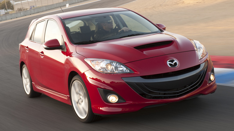 Red Mazdaspeed3 driving around a track