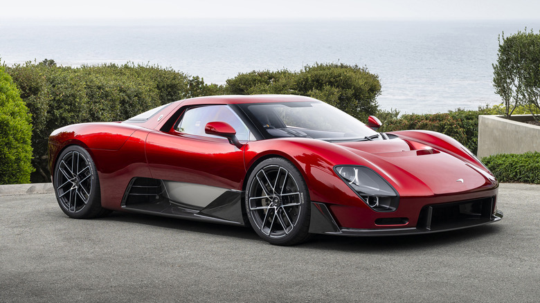 Front 3/4 view of a red McLaren McL 6GT