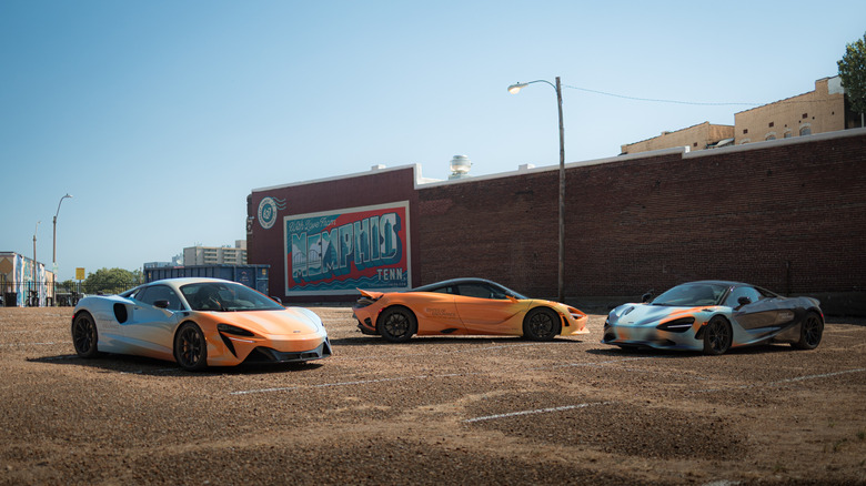 Three McLaren supercars parked in an empty lot during the company's 'Streets of Endurance' US road trip