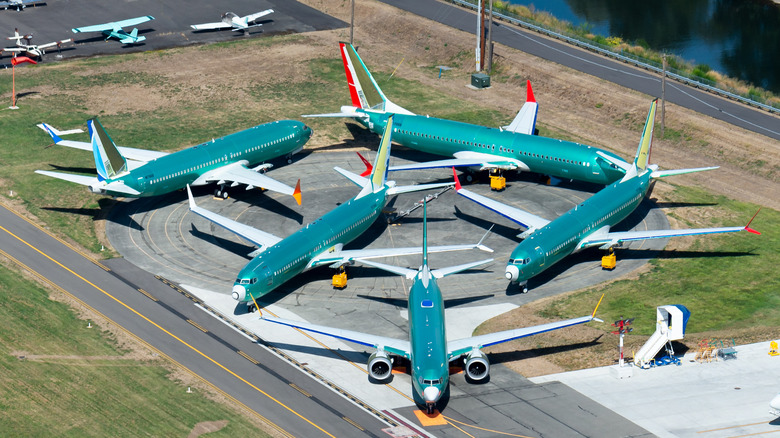 Multiple engineless Boeing 737 MAX outside the assembly line parked at Renton Airport waiting for flight tests, painting and delivery.