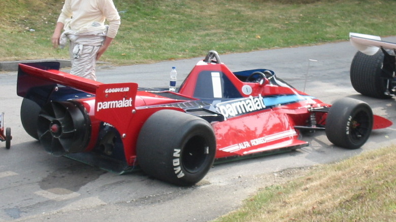 A Brabham BT46B Formula 1 fan car on a narrow lane track, stationary rear angle image