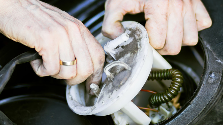 An in-tank electric fuel pump being installed by a technician.