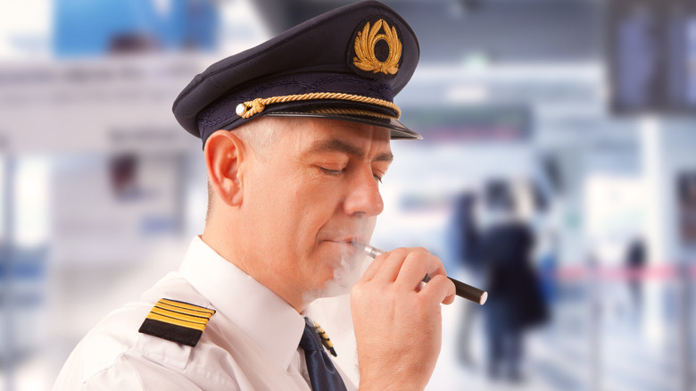 airline pilot with epilets smoking a vape