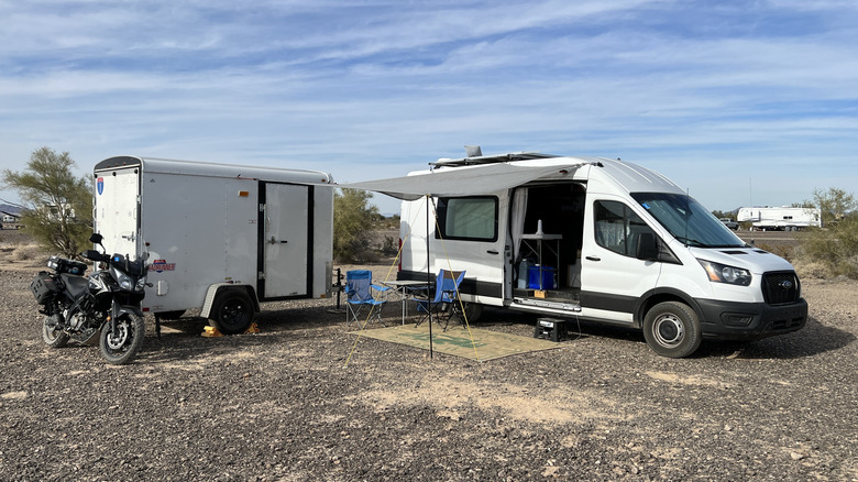 My van camp in Quartzsite, Arizona, consisting of my Ford Transit, Suzuki V-Strom 650, and cargo trailer