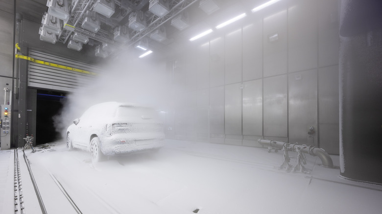 Rear 3/4 view of a snow-covered Mercedes-Benz GLB in a wind tunnel