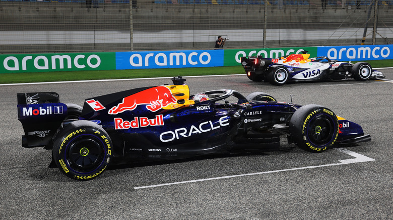 Arvid Lindblad of Great Britain driving the (41) Visa Cash App Racing Bulls VCARB 03 RB Ford and Max Verstappen of the Netherlands driving the (3) Oracle Red Bull Racing RB22 Red Bull Ford practice their race start procedures during day three of F1 Testing at Bahrain International Circuit on February 20, 2026 in Bahrain, Bahrain.
