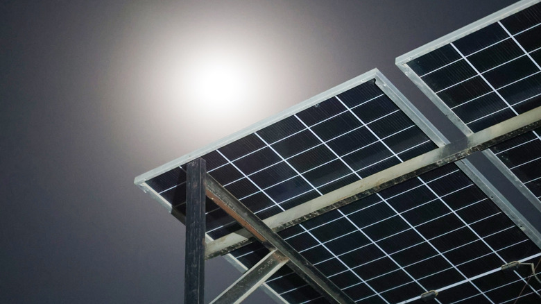 A solar array under the moonlight at night