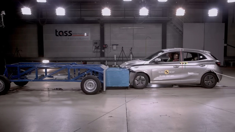 screenshot from the crash test showing a side angle of a silver MG 3 hitting the NCAP test sled with no airbags deployed yet