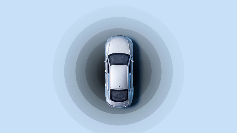 A top-down image of a silver sedan surrounded by gradient-colored circles that make it look like it's being tracked.