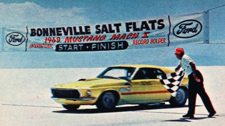A yellow Ford Mustang Mach 1 crosses the finish line at Bonneville in 1968