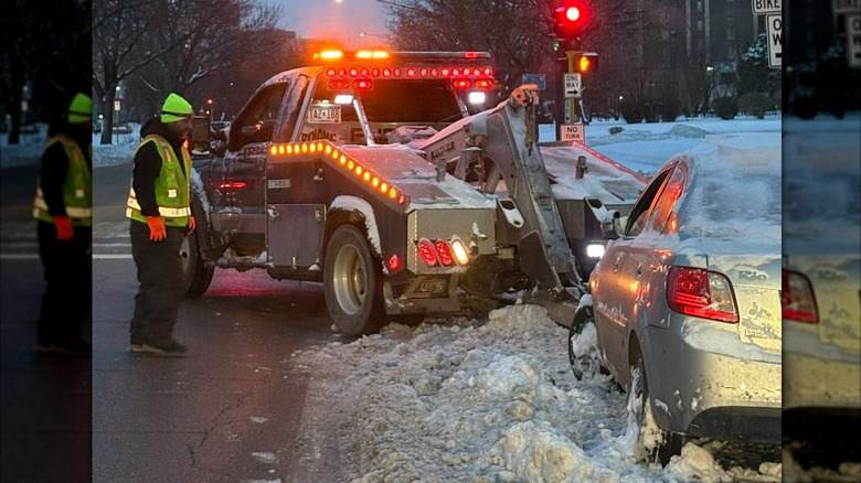 A Leo's Tow tow truck picking up a car abandoned after an ICE arrest before returning it to the family