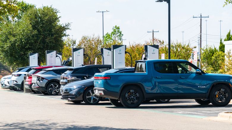 A group of vehicles parked at an Electrify America charging station