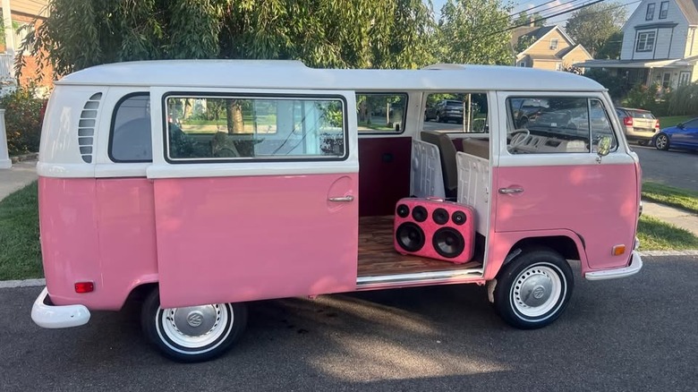 A pink Volkswagen Bus