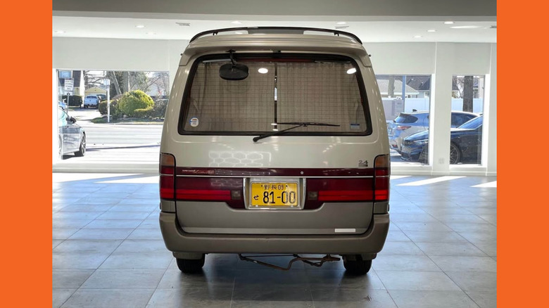A Toyota HiAce van from the rear