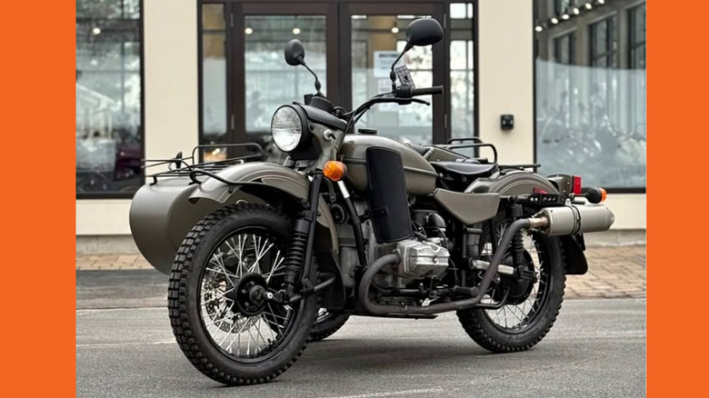 A desaturated green Ural Patrol motorcycle