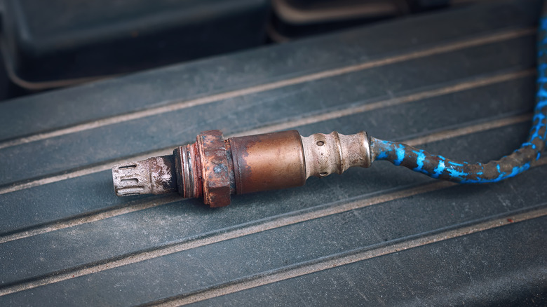 Close up of old, dirty oxygen sensor from a car