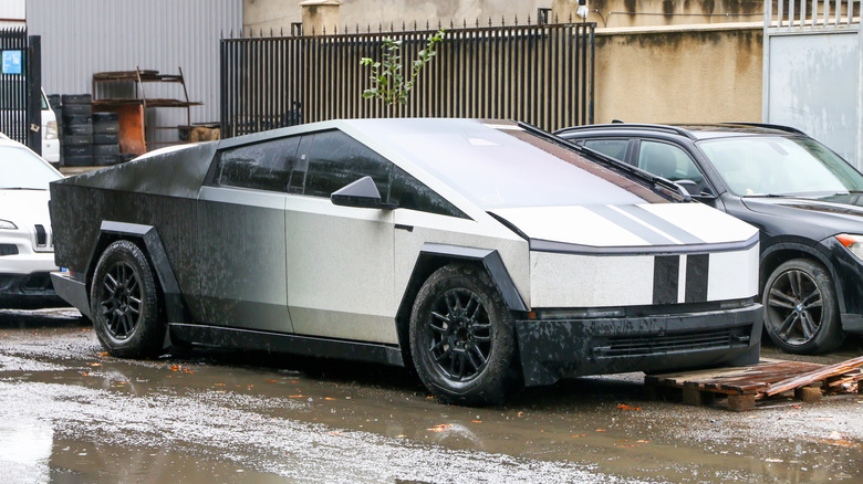 A destroyed Tesla Cybertruck in a repair shop