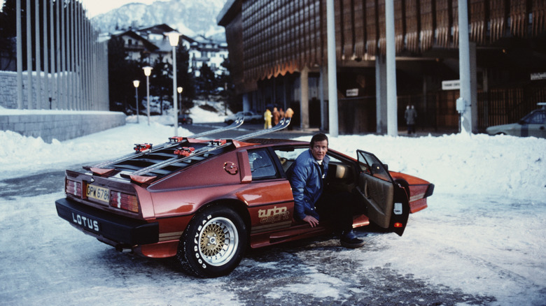 Roger Moore as James Bond with a red Lotus Esprit