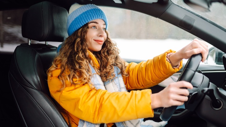 Young woman driving on a cold day