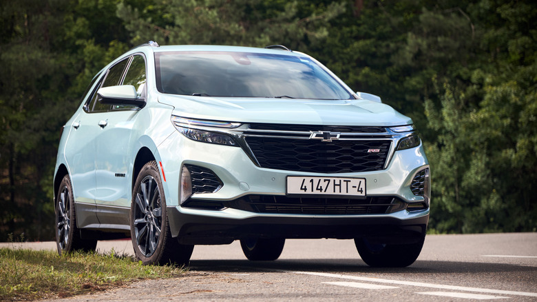 A blue Chevy Equinox on the side of the road.