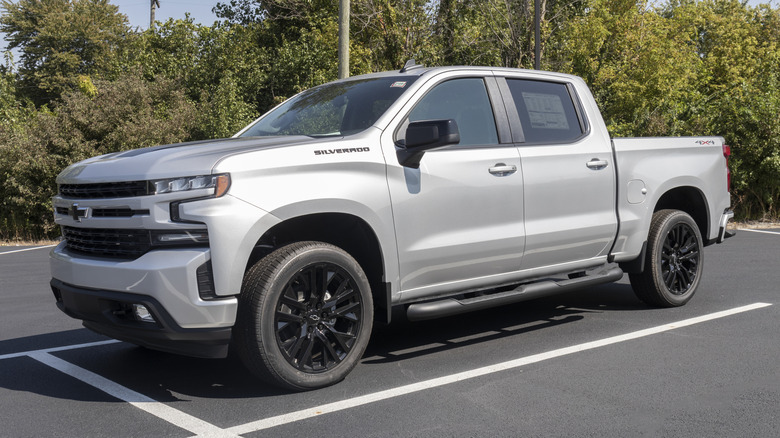 A Chevy Silverado sitting in a parking spot.