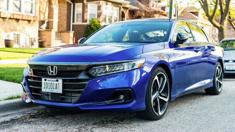 A blue Honda Accord parked in a neighborhood.