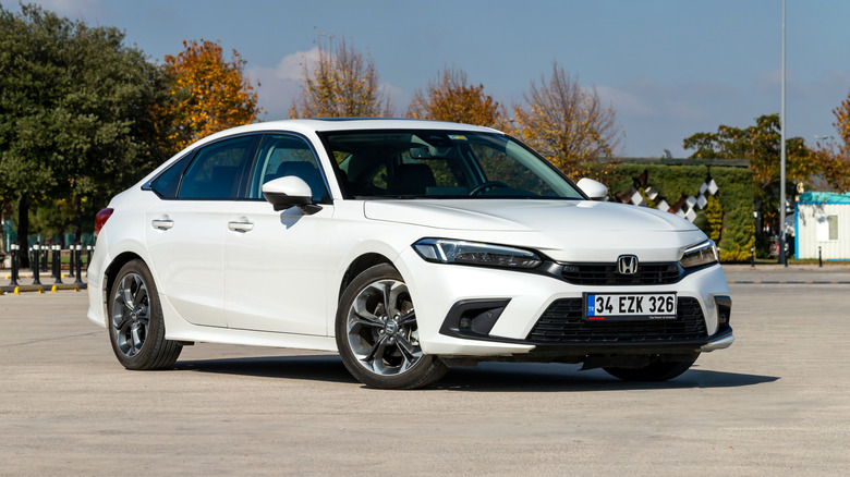 A white Honda Civic in a parking lot.