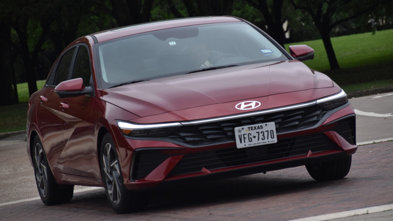 A red Hyundai Elantra sitting in a parking lot.
