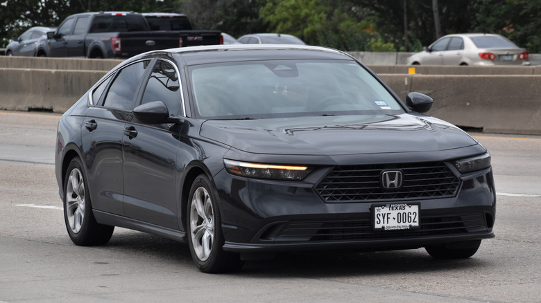 A black Honda Accord driving on the highway