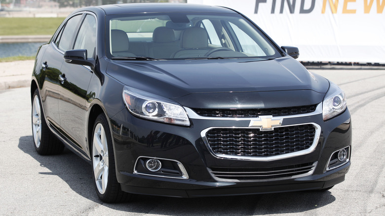 A blue Chevrolet Malibu sits parked.