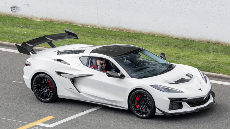 A white C8 generation Corvette ZR1 driving along the road.