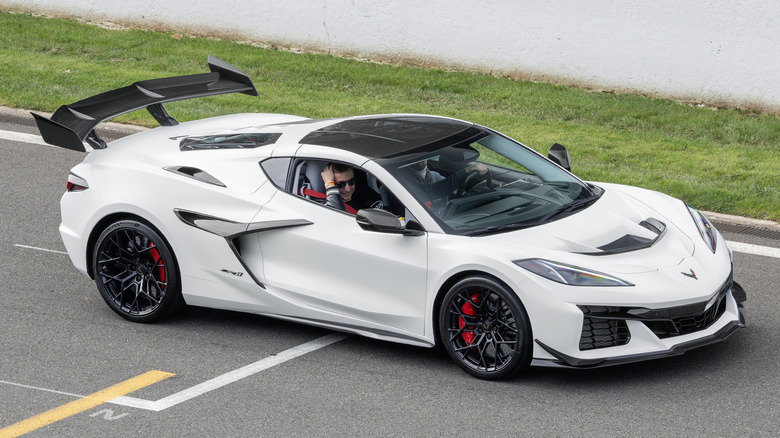 A white C8 generation Corvette ZR1 driving along the road.
