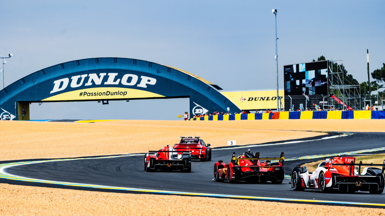A turn at the 24 Hours of LeMans endurance race showing cars approaching around an S-bend