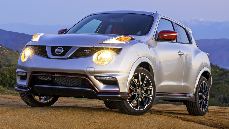 A silver 2016 Nissan Juke Nismo RS parked with twilit mountains in the background