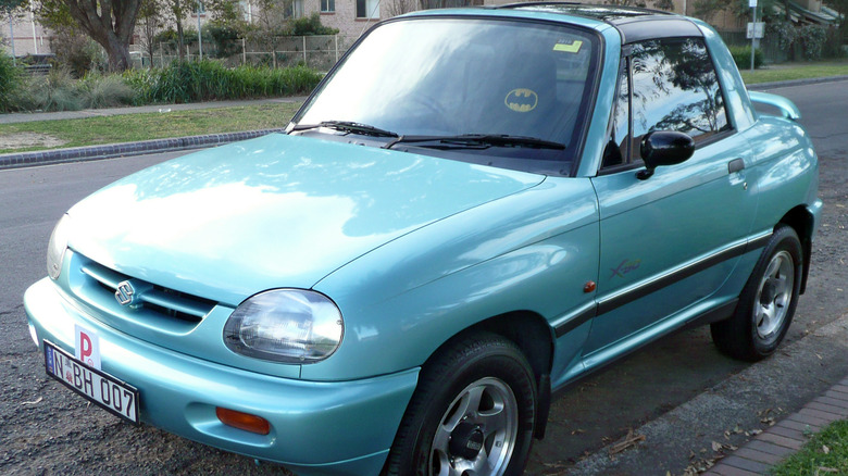 A light blue Suzuki X-90 SUV coupe parked on a road in Australia
