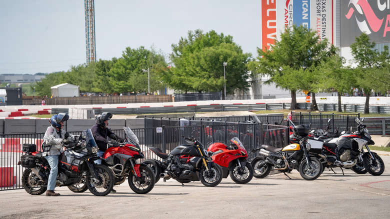 Motorcyclists getting on their bikes after the GP
