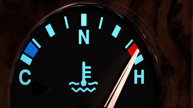 Engine temperature gauge with the needle pointing in the Hot zone