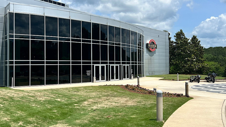 The entrance of the Barber Vintage Motorcycle Museum with two visitors' bikes parked outside