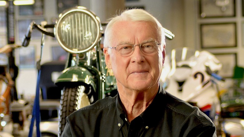George Barber Jr. standing in front of a vintage motorcycle inside the museum that bears his name