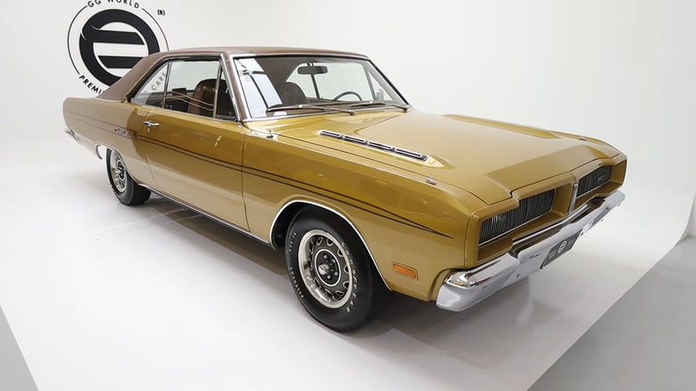 A pristine gold-colored Brazilian-spec Dodge Charger R/T coupe in a brightly lit white studio.